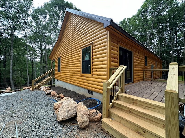 view of property exterior featuring a wooden deck