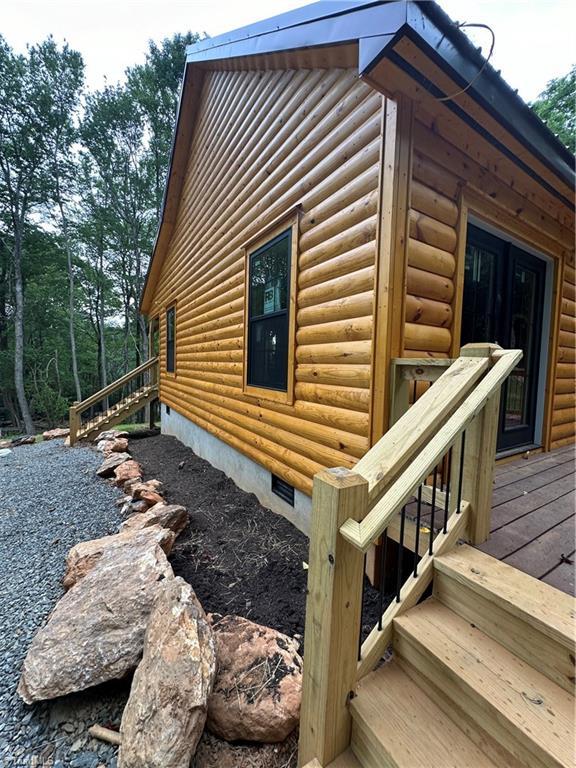 view of side of home with a wooden deck