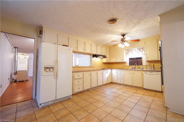 kitchen featuring light wood-type flooring, white appliances, tasteful backsplash, and ceiling fan