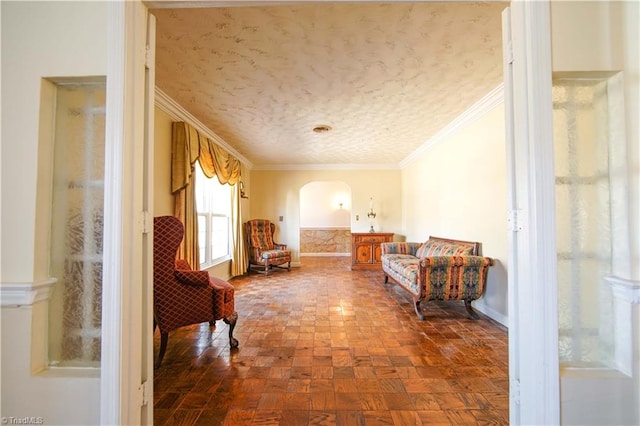 sitting room featuring dark parquet floors and ornamental molding