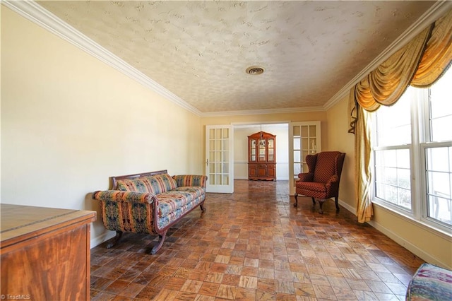 sitting room featuring ornamental molding and french doors