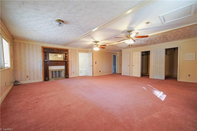 unfurnished living room featuring carpet flooring, ceiling fan, ornamental molding, and a textured ceiling