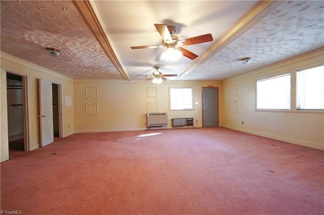 interior space with a textured ceiling, ceiling fan, crown molding, and heating unit