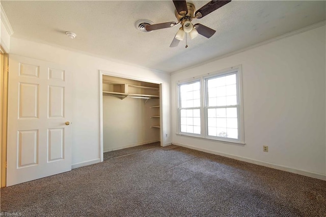 unfurnished bedroom featuring carpet, a closet, ceiling fan, and ornamental molding