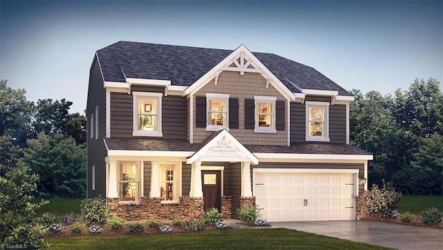 craftsman inspired home with an attached garage and driveway