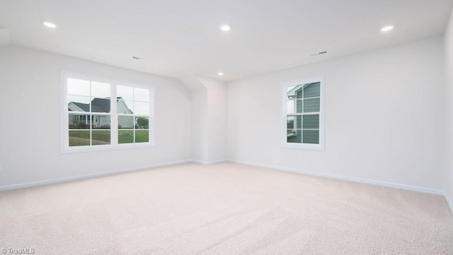 spare room featuring recessed lighting, baseboards, and light colored carpet