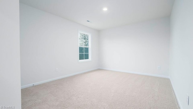 unfurnished room with recessed lighting, light colored carpet, and baseboards