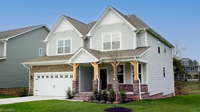 craftsman house featuring stone siding, driveway, a porch, and a front lawn