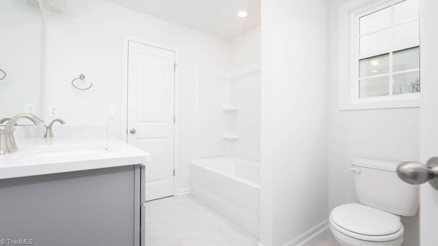 bathroom with tub / shower combination, baseboards, toilet, and vanity