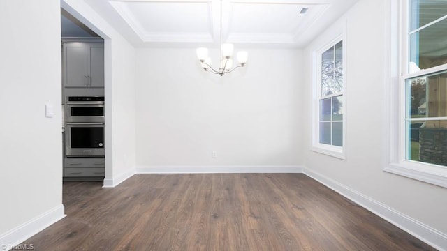 unfurnished dining area featuring dark wood finished floors, baseboards, coffered ceiling, and a chandelier