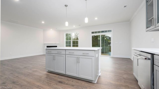 kitchen with crown molding, open floor plan, dishwasher, a fireplace, and dark wood-style floors