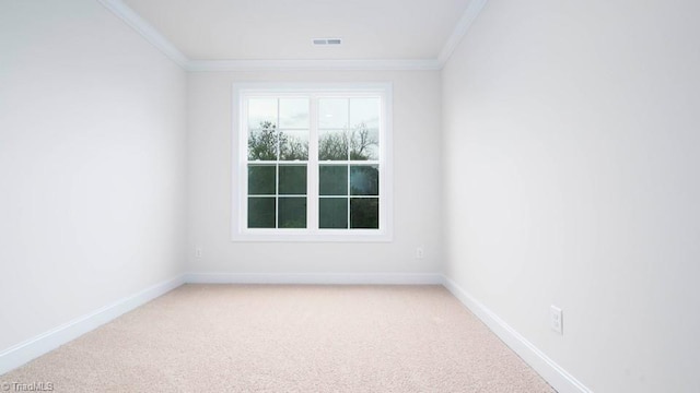 spare room featuring baseboards, crown molding, and carpet