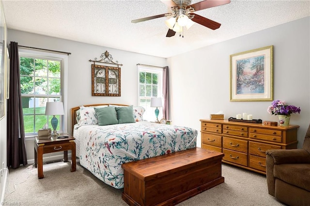 3714 Courtland Cir, Thomasville, NC 27360 - bedroom featuring light carpet, multiple windows, a textured ceiling, and a ceiling fan
