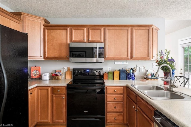 3714 Courtland Cir, Thomasville, NC 27360 - kitchen with black appliances, light countertops, a textured ceiling, and brown cabinets