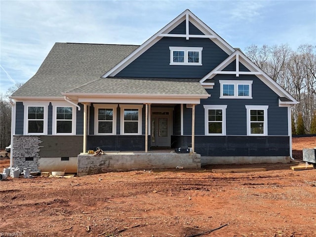 view of front of property featuring covered porch, roof with shingles, and crawl space