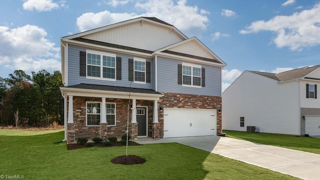 247 Lisa Ln, Winston-Salem, NC 27107 - craftsman house with concrete driveway, an attached garage, a front lawn, and stone siding