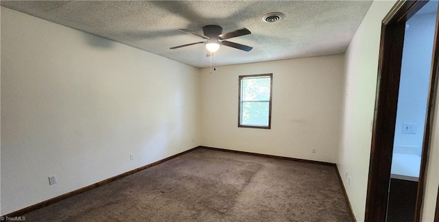 carpeted spare room with visible vents, baseboards, a textured ceiling, and a ceiling fan