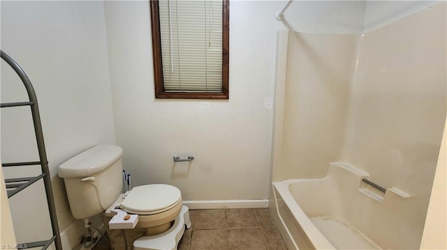 bathroom featuring tile patterned floors, shower / bathing tub combination, baseboards, and toilet