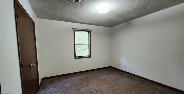 unfurnished bedroom featuring carpet flooring, a textured ceiling, and baseboards