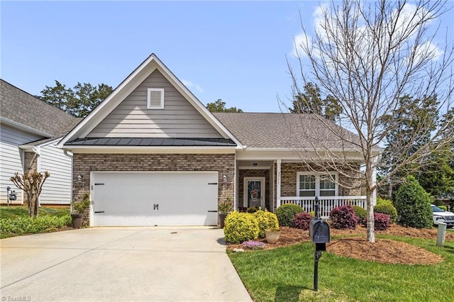 craftsman-style home featuring a standing seam roof, driveway, covered porch, brick siding, and metal roof