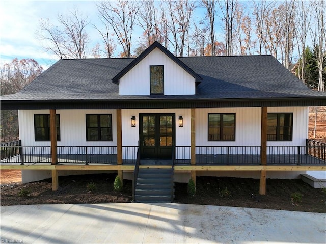 modern inspired farmhouse featuring a porch and french doors