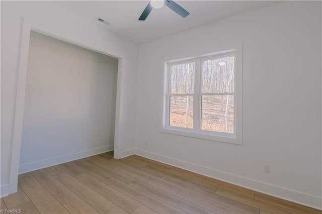 spare room featuring light wood-type flooring and ceiling fan