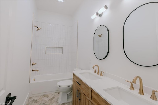 full bathroom with vanity, tiled shower / bath combo, and toilet