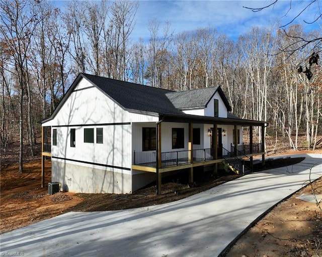 view of front of home with cooling unit and covered porch