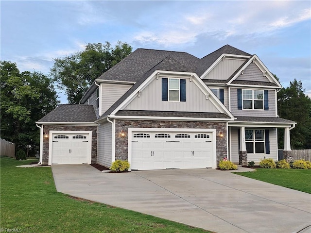 craftsman inspired home featuring a garage and a front yard