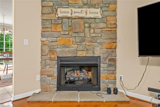 5805 Pine Hall Rd, Walnut Cove, NC 27052 - detailed view of a stone fireplace, baseboards, and wood finished floors