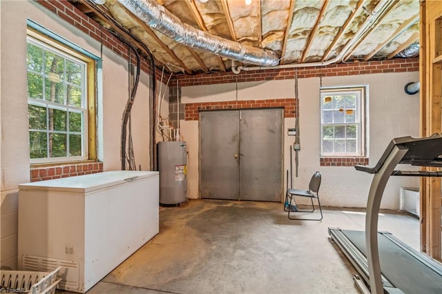 5805 Pine Hall Rd, Walnut Cove, NC 27052 - below grade area featuring white fridge, water heater, and healthy amount of natural light