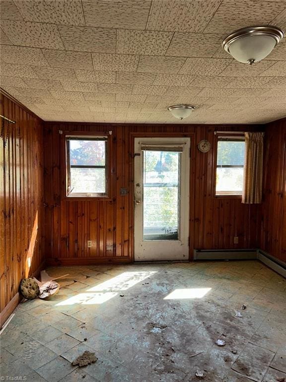 misc room with wooden walls and plenty of natural light