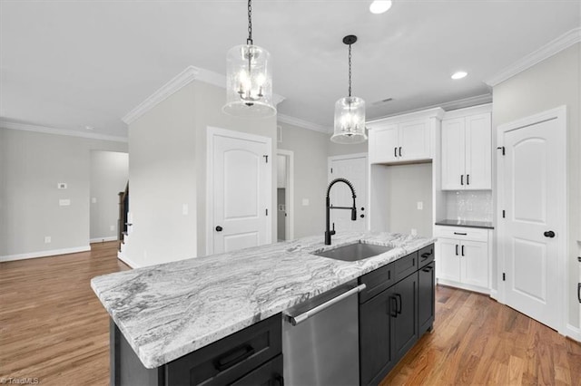 kitchen featuring a sink, white cabinetry, light wood-type flooring, dishwasher, and an island with sink