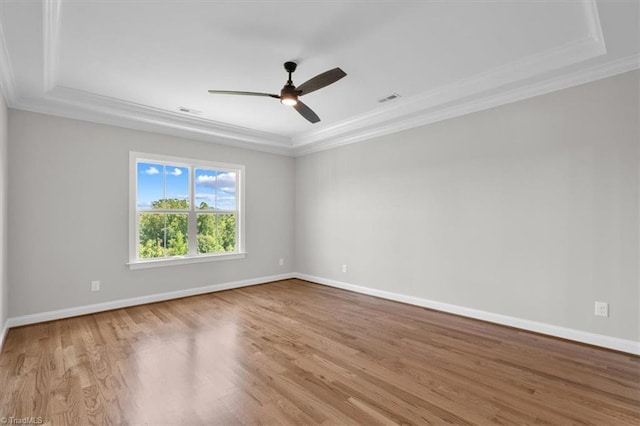 unfurnished room with ceiling fan, crown molding, baseboards, and wood finished floors