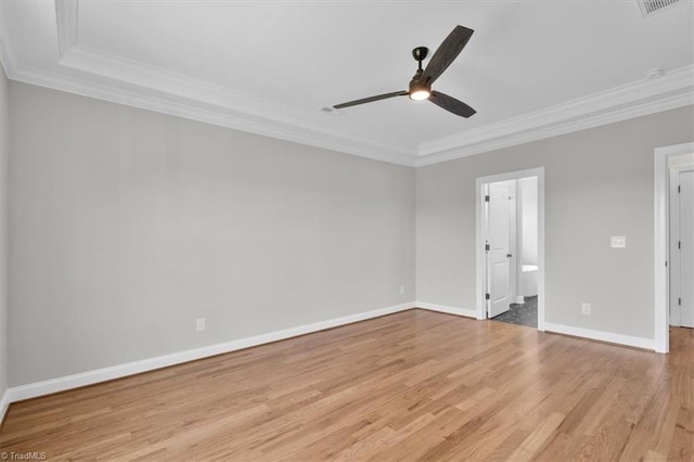 spare room with ceiling fan, crown molding, baseboards, and wood finished floors