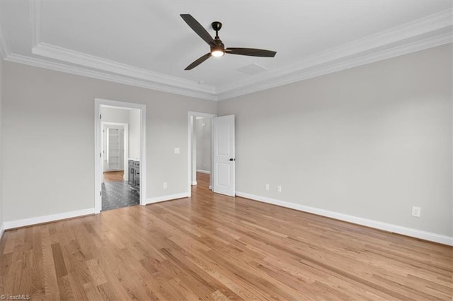 unfurnished bedroom with a ceiling fan, baseboards, light wood finished floors, ensuite bath, and crown molding