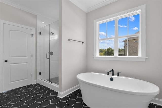 full bath featuring baseboards, a stall shower, a soaking tub, and crown molding