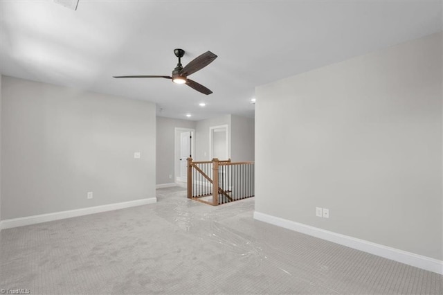 spare room featuring a ceiling fan, recessed lighting, and baseboards