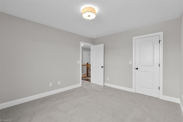 unfurnished bedroom with carpet flooring and baseboards