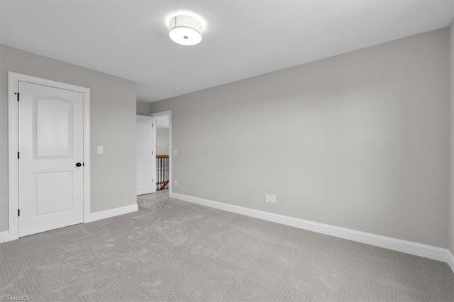 unfurnished bedroom featuring carpet and baseboards