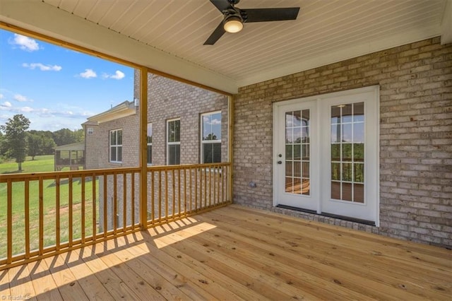 deck with ceiling fan, french doors, and a lawn