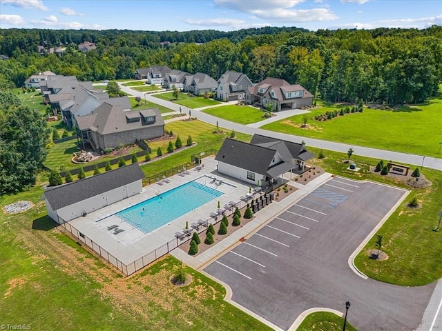 drone / aerial view with a residential view and a view of trees