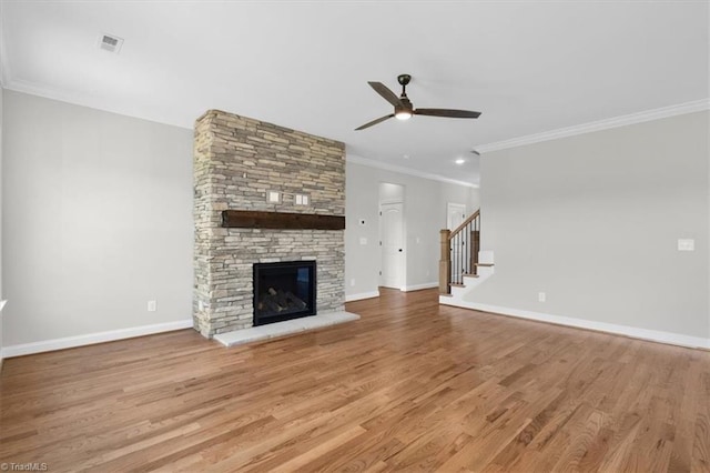 unfurnished living room featuring visible vents, stairway, baseboards, and wood finished floors