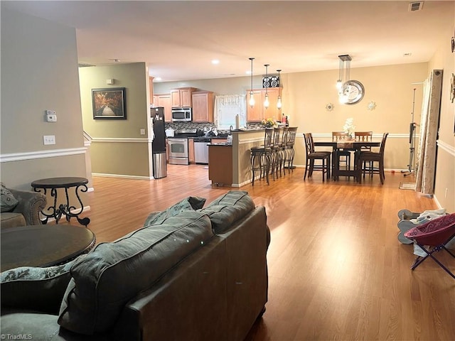 living room with light hardwood / wood-style flooring