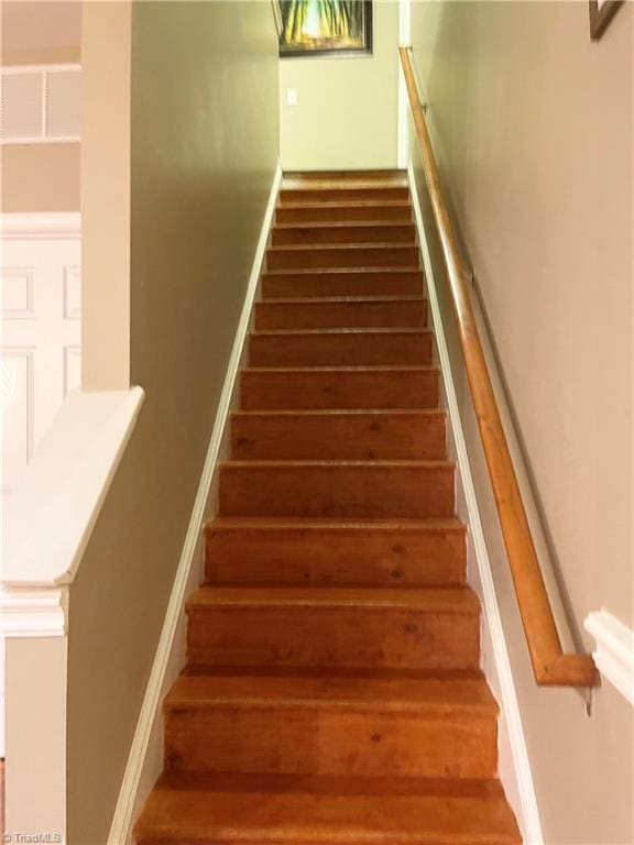 staircase featuring hardwood / wood-style flooring