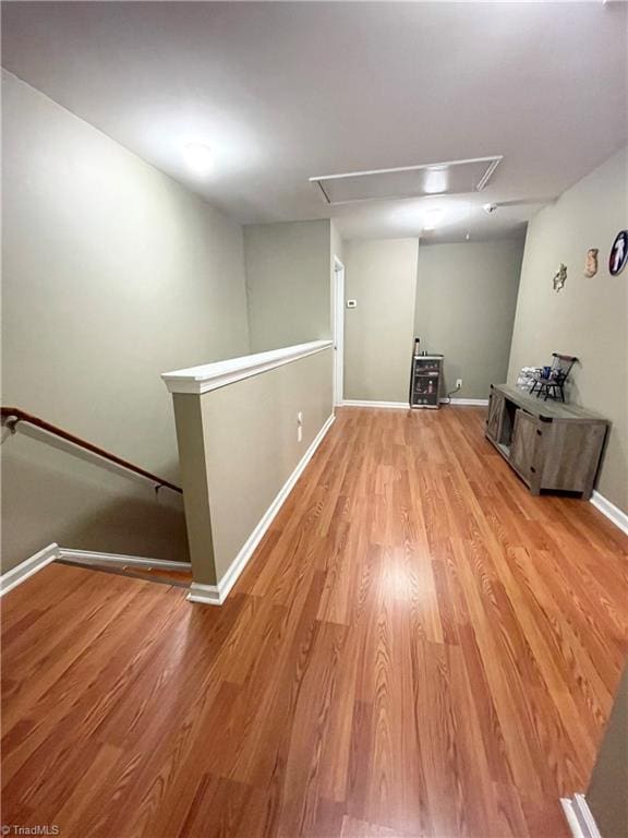 basement with light hardwood / wood-style floors