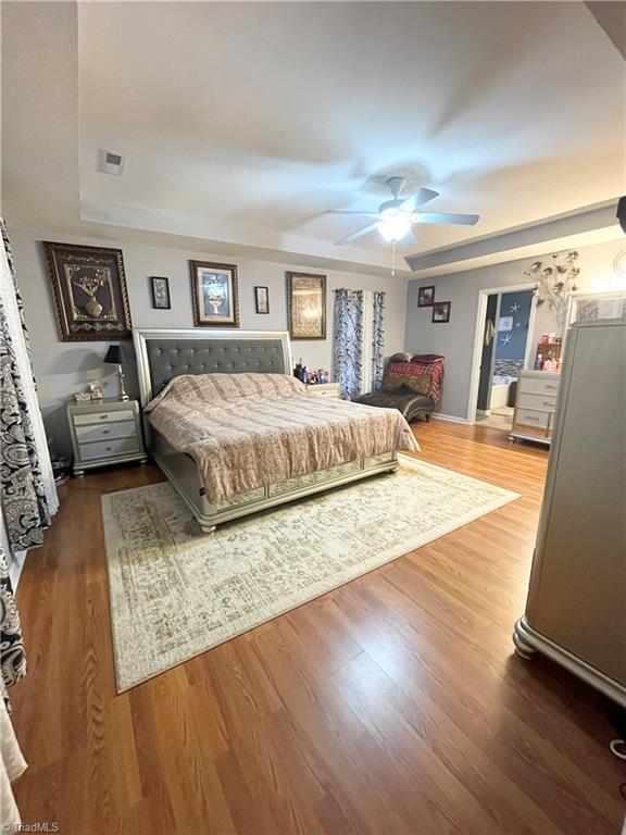 bedroom featuring dark hardwood / wood-style floors and ceiling fan