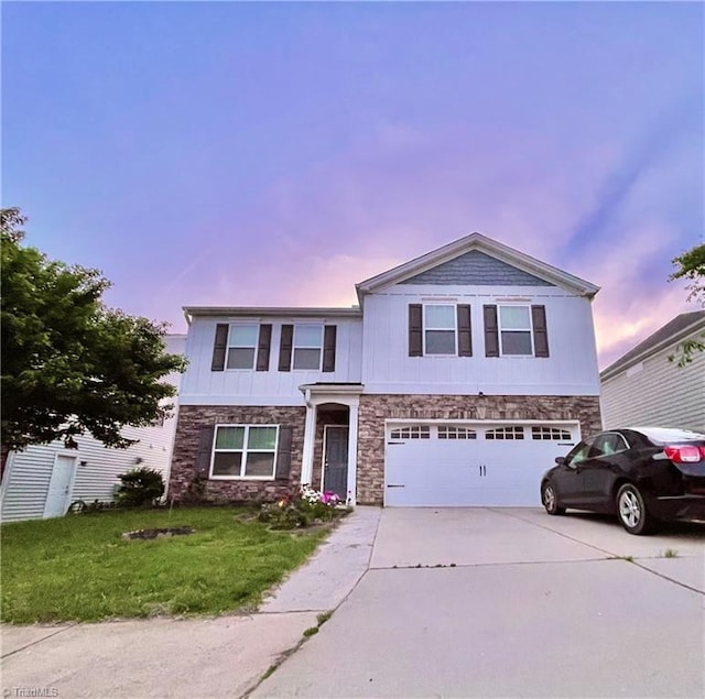 view of front of home with a yard and a garage