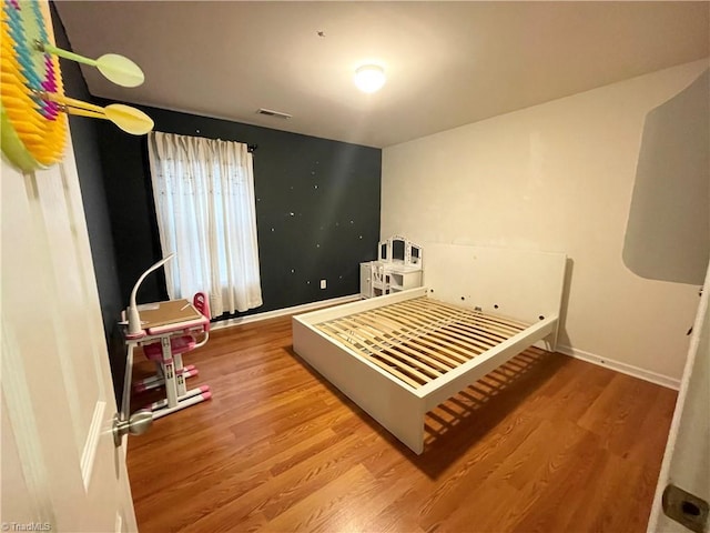 bedroom featuring wood-type flooring