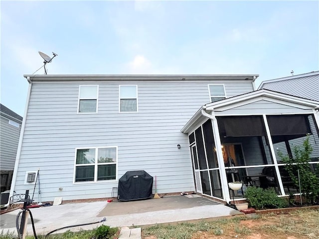 back of property featuring a sunroom and a patio